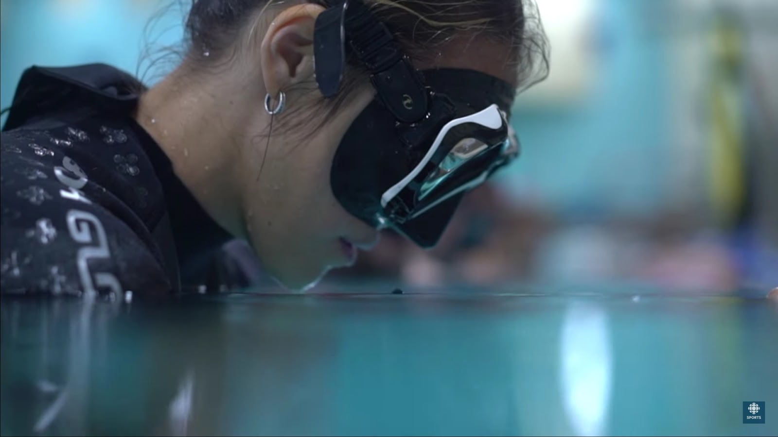 Woman in mask going underwater