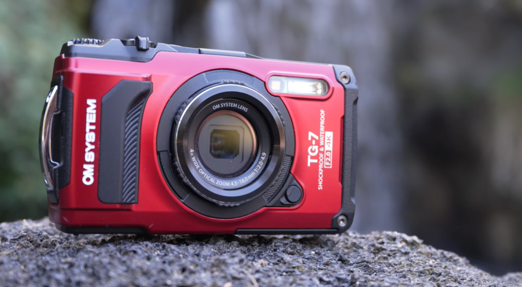 Un appareil photo rouge robuste posé sur un rocher